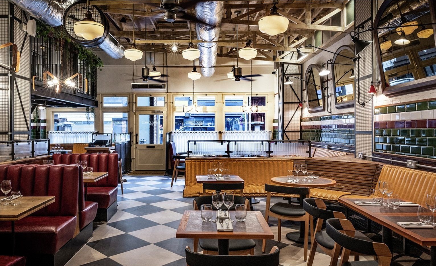 Bar and restaurant interior fit-out with brass shelving and upholstered seating